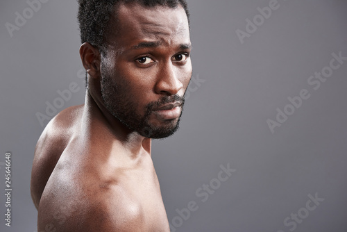 Close up of a brave Afro American man looking at you