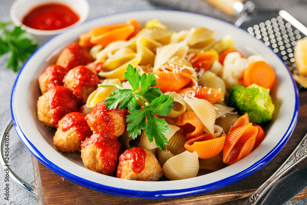 Meatballs with Conchiglie, broccoli and a cauliflower in a plate on a table. Diet food. Meatballs with Conchiglie, broccoli and a cauliflower in a plate on a table. Diet food.