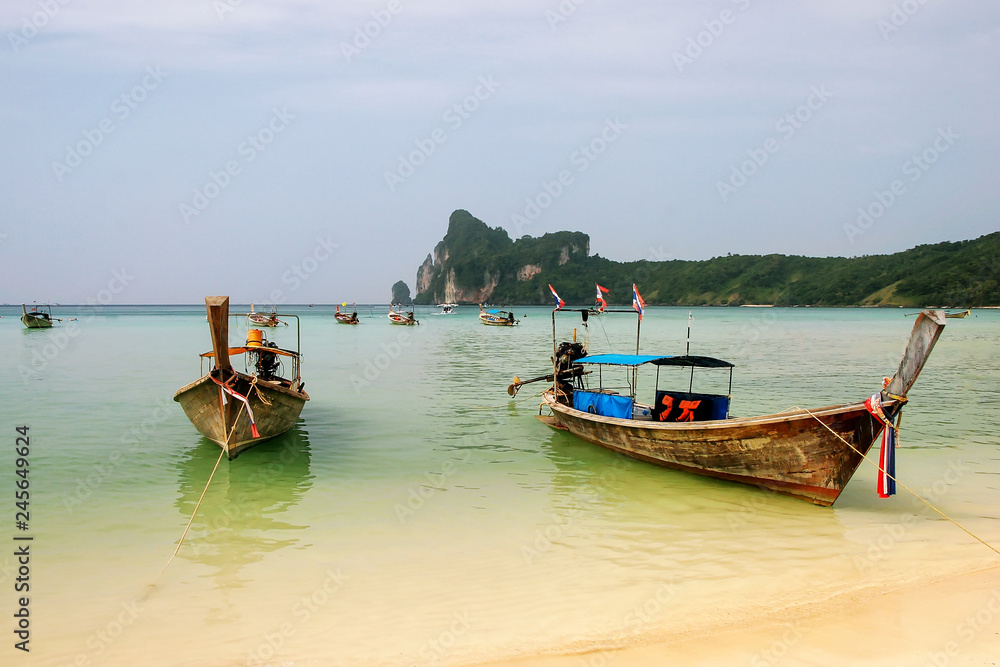 Longtail boats anchored at Ao Loh Dalum beach on Phi Phi Don Island, Krabi Province, Thailand Longtail boats anchored at Ao Loh Dalum beach on Phi Phi Don Island, Krabi Province, Thailand