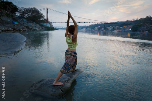 Woman make yoga pose rishikesh.
