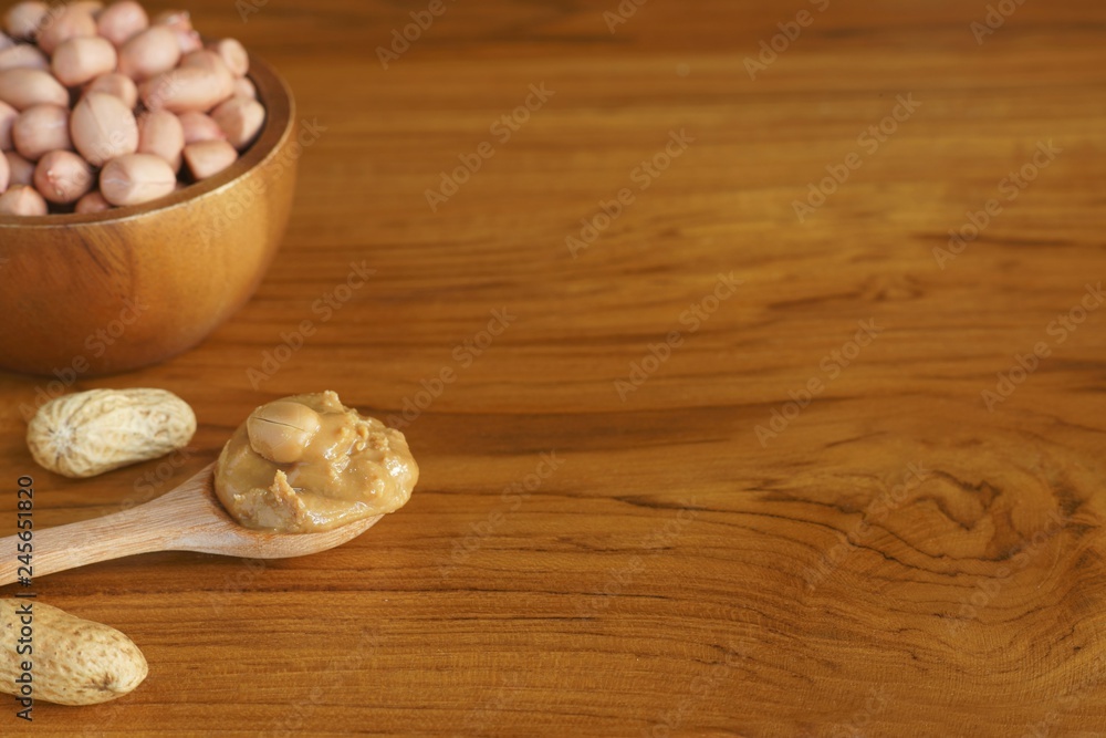 Peanut in wooden bowl on classic wooden table background, peanut butter Peanut in wooden bowl on classic wooden table background, peanut butter