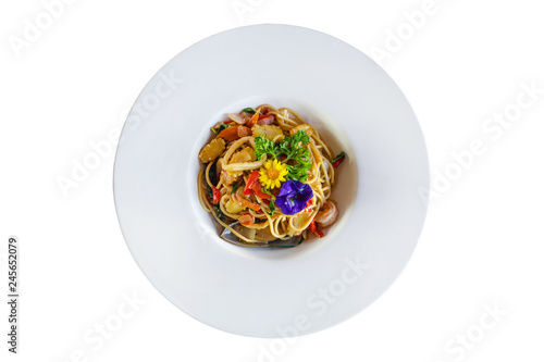 Stir-fried spicy spaghetti with seafoods on white background.
