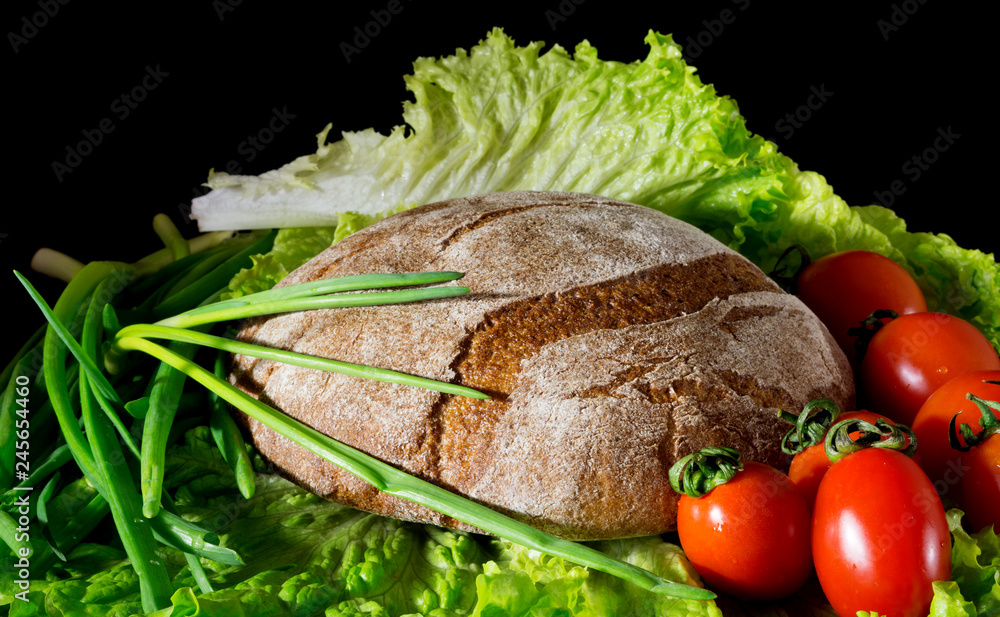healthy breakfast of bread and vegetables. Bread, tomatoes, vegetables on a dark background.