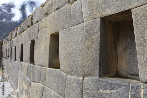 Fototapeta Naklejka Na Ścianę i Meble -  Cusco, Peru - Oct 22, 2018: Trapezoidal stone windows and doors at the Ollanytambo archaeological site in the Sacred Valley