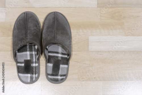 A pair of slippers on a wooden floor