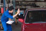 auto service, repair, maintenance concept mechanic with clipboard and car owner businessman. excellent service,safe driving