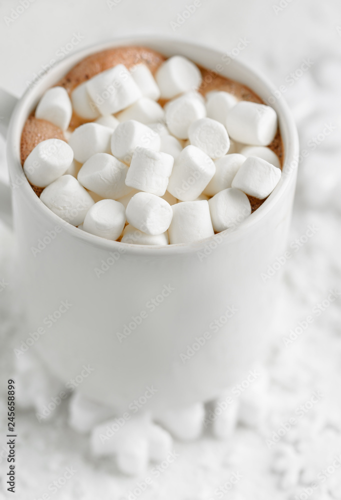 cocoa with marshmallows on a winter snowy background cocoa with marshmallows on a winter snowy background
