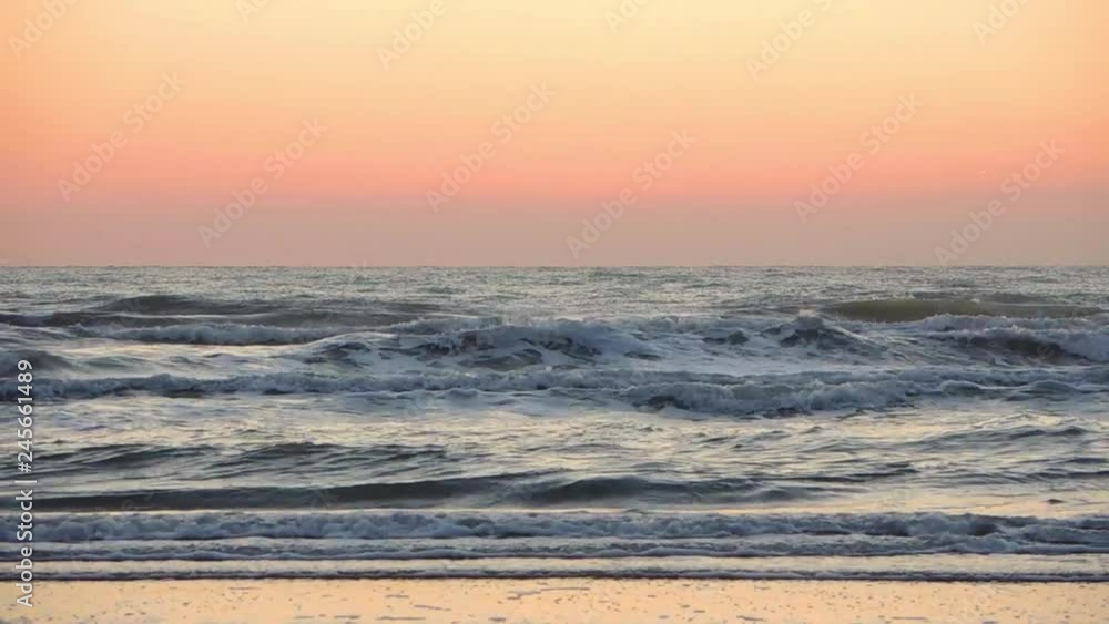 Riccione, Italy. Sea waves along the seashore at sunrise in summer Riccione, Italy. Sea waves along the seashore at sunrise in summer