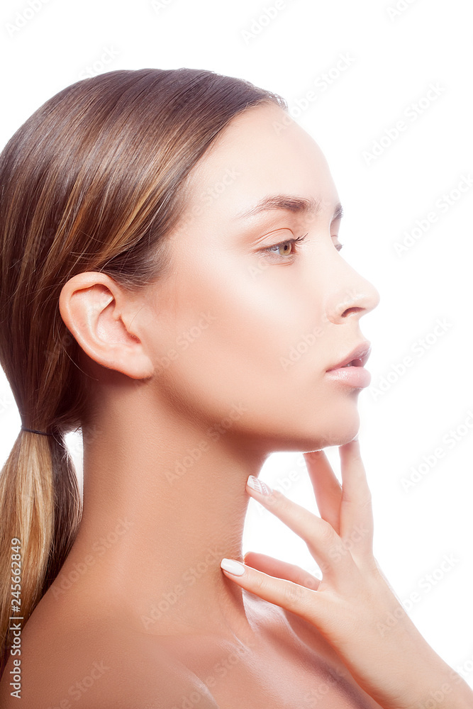 Beauty model girl studio portrait. Young caucasian woman with perfect clean fresh skin, green eyes, natural lips and nude makeup, hand near chin. Skincare woman health facial treatment concept