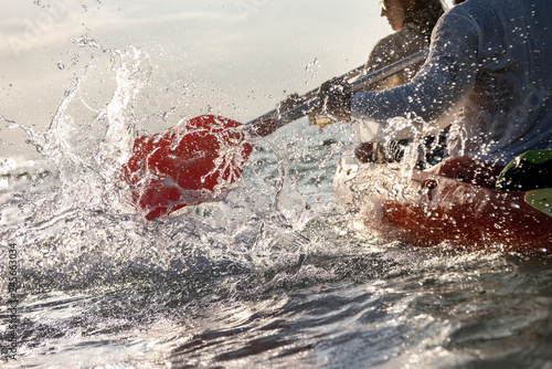 Slika na platnu Closeup photo of splashes from kayak or canoe paddle at sea bay