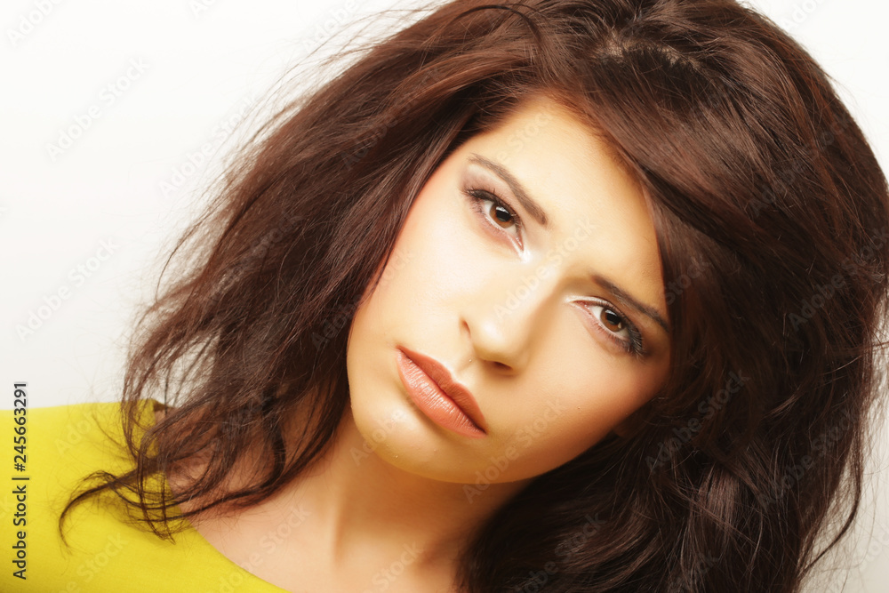 Young woman l looking at camera over white background. Young woman l looking at camera over white background.