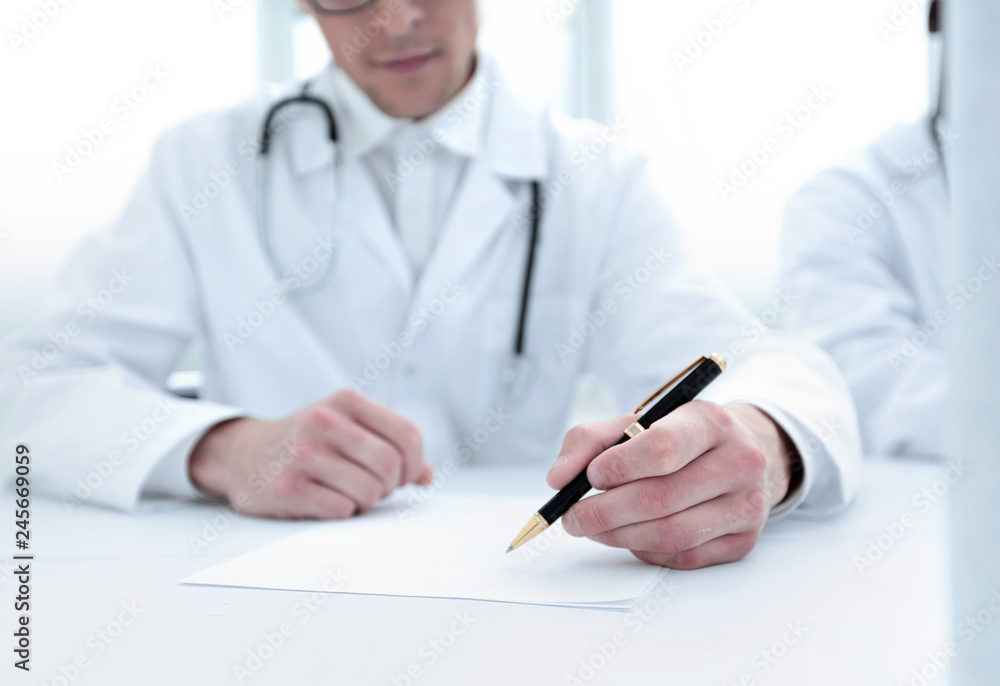 close up.the doctor makes a journal entry close up.the doctor makes a journal entry