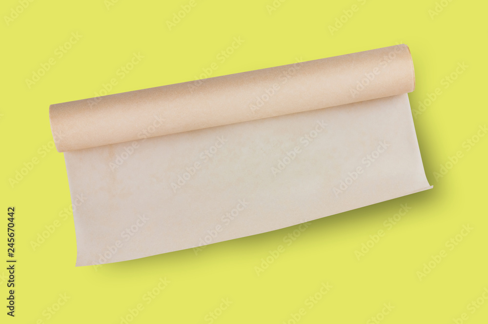 One roll of brown baker paper in center on yellow table on cuisine. Top view. Flat lay. Cooking concept One roll of brown baker paper in center on yellow table on cuisine. Top view. Flat lay. Cooking concept