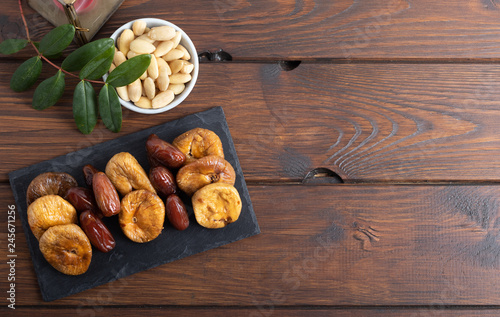 Dried figs and dates on a platter on a white background
