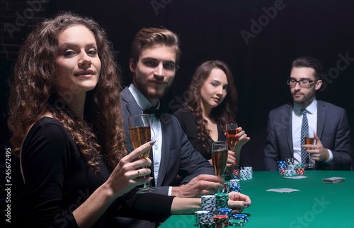 beautiful woman sitting at a table in a casino