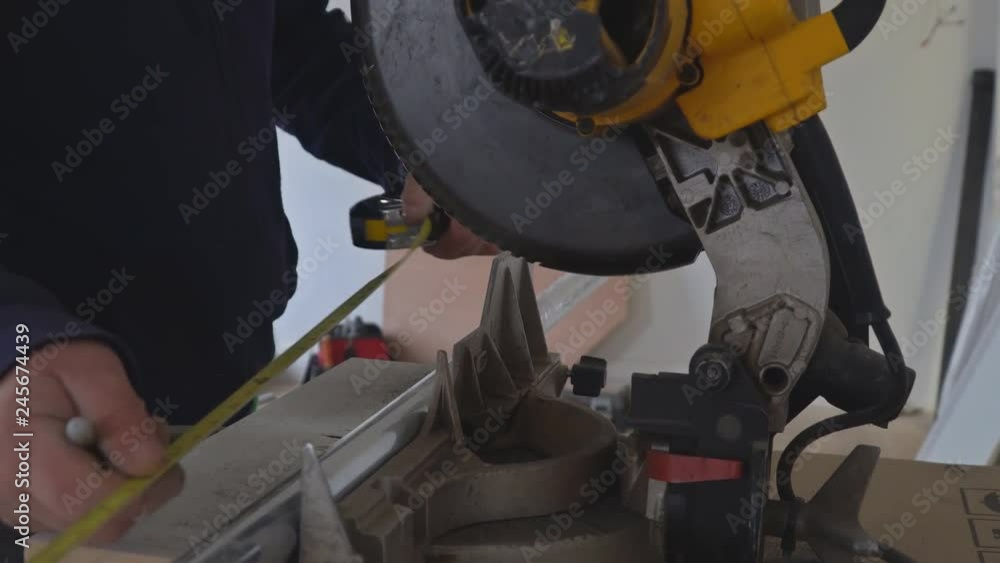 Craftsman sawing metal with disk grinder in sparks while grinding iron Craftsman sawing metal with disk grinder in sparks while grinding iron