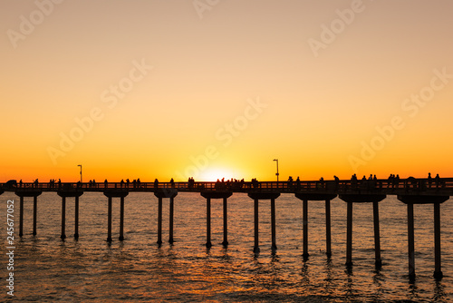 People are fishing and enjoying their sunset at Ocean Beach  San Diego  California