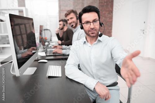 modern businessman in a headset reaching out for a handshake