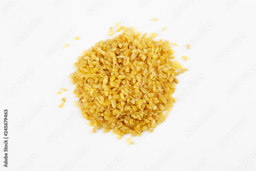 Pile of raw bulgur seeds on a white background Pile of raw bulgur seeds on a white background