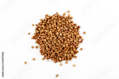 Pile of raw buckwheat seeds on a white background