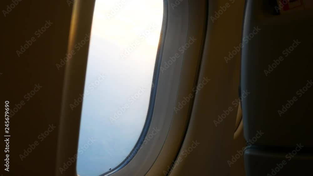 Plane,airplane window inside the plane cabin with sunbeam light while sun set Plane,airplane window inside the plane cabin with sunbeam light while sun set