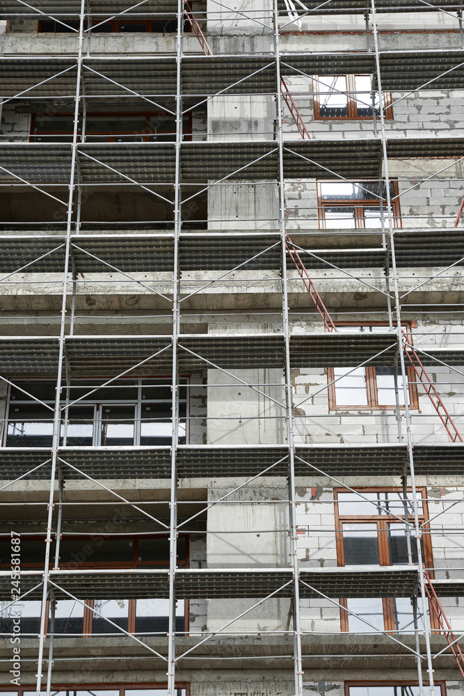 new building under construction, scaffolding and concrete