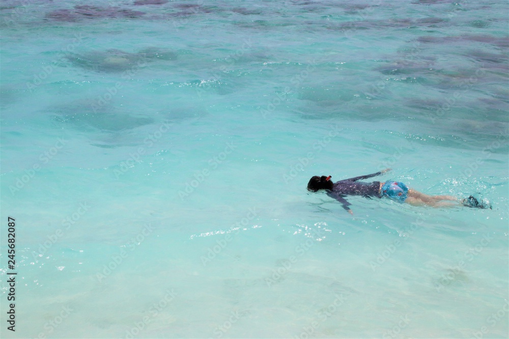 Woman snorkeling in beautiful sea in Maldive
