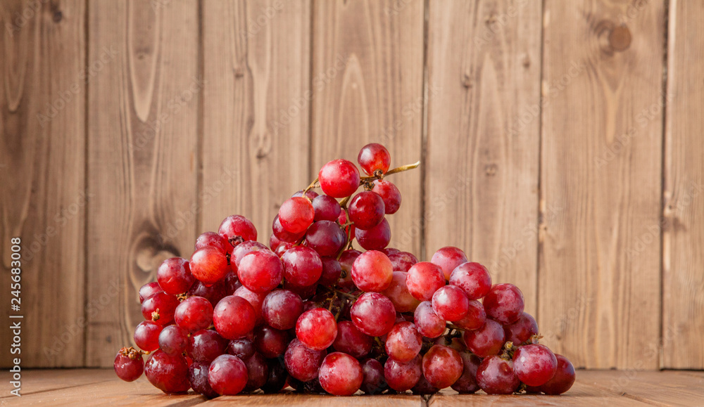 branch of ripe organic grapes on wooden rustic background branch of ripe organic grapes on wooden rustic background
