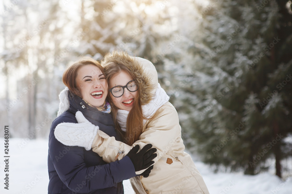 Two young, pretty women in a snowy forest. Two young, pretty women in a snowy forest.