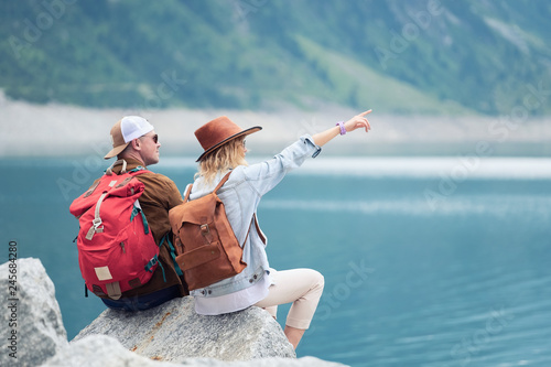 Travelers couple look at the mountain lake. Travel and active life concept with team. Adventure and travel in the mountains region in the Austria. Travel - image photo