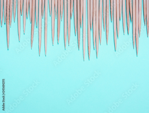 Sharp wooden spikes on a blue background