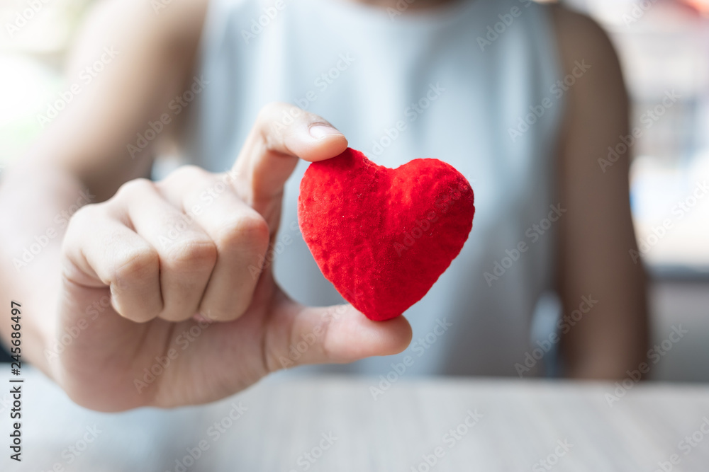 woman hand holding Red heart shape in office. Love, Happy Valentines day holiday and healthy Insurance concept woman hand holding Red heart shape in office. Love, Happy Valentines day holiday and healthy Insurance concept