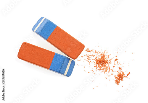 Two erasers and eraser scrap on white background. Top view. photo