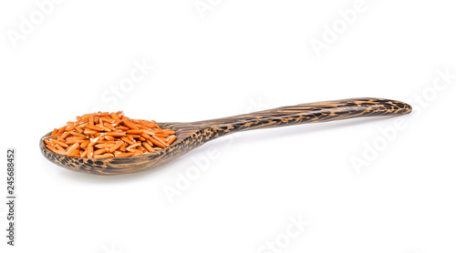 brown rice in wood spoon isolated on white background