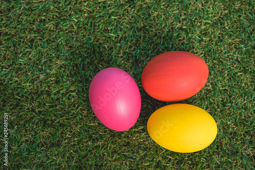 Top view of Easter eggs clean on grass background