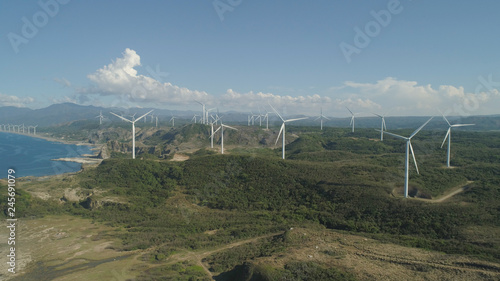 Aerial view of Windmills for electric power production on the coast. Bangui Windmills in Ilocos Norte, Philippines. Ecological landscape: Windmills, sea, mountains. Pagudpud