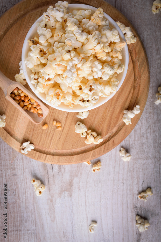 Salt popcorn on the wooden table, selective focus Salt popcorn on the wooden table, selective focus