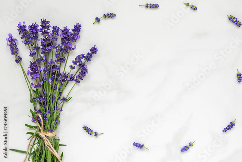 Fototapeta Naklejka Na Ścianę i Meble -  lavender flowers bouquet on white marble table with copy space for your text. top view. flat lay
