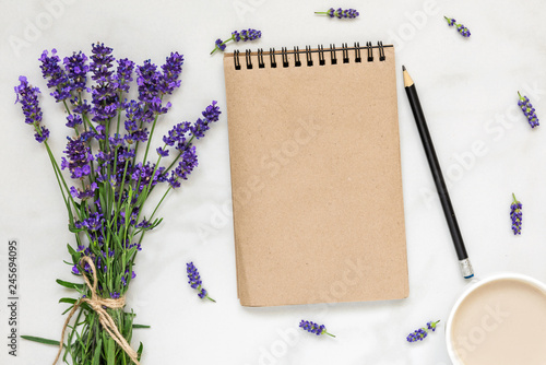 Fototapeta Naklejka Na Ścianę i Meble -  mock up greeting card in frame made of lavender flowers with bouquet and cup of cappuccino