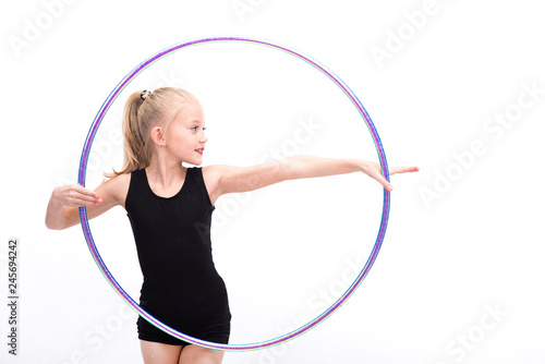 Teenager girl involved in rhythmic gymnastics with gymnastic hoop © Rakursstudio