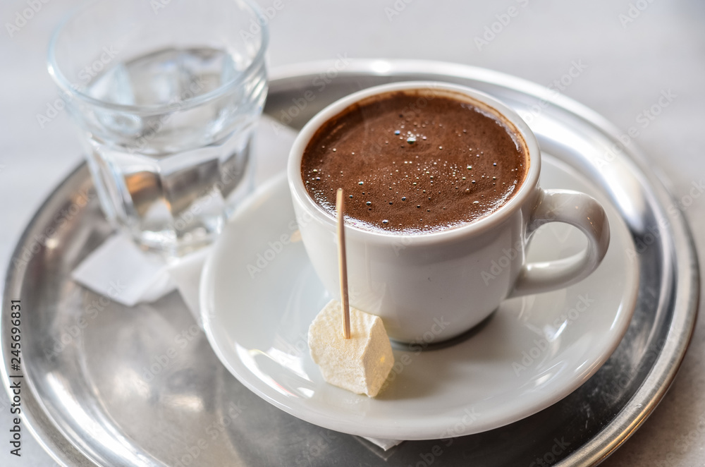 Turkish coffee with turkish delight on metal plate Turkish coffee with turkish delight on metal plate