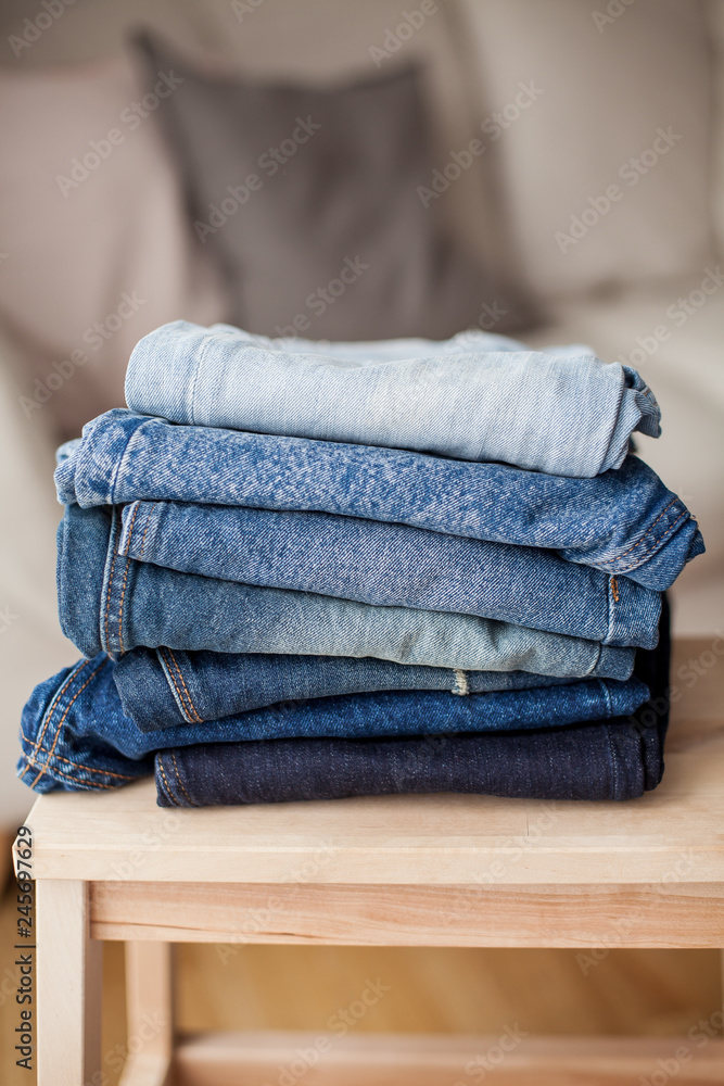 Jeans, denim cotton, blue. Stack of jeans in the interior. Clothing. Jeans, denim cotton, blue. Stack of jeans in the interior. Clothing.