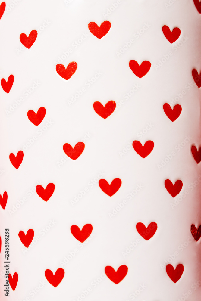 Red hearts painted on white ceramic.