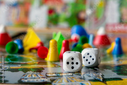 concept of board games. Dice, chips and cards on a green background copy space