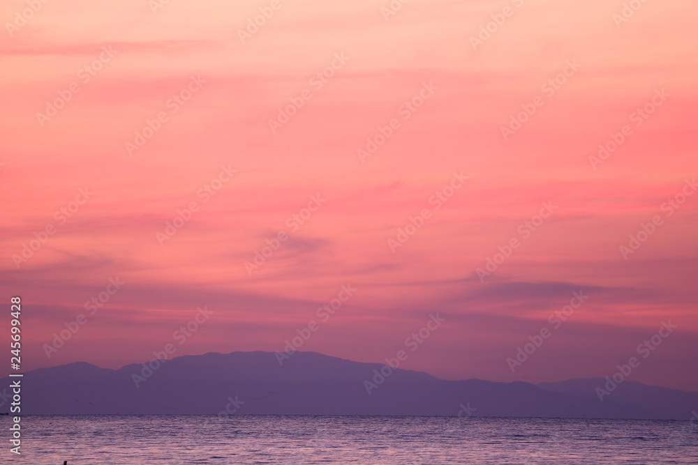 Stunning Pastel Pink and Purple Sunrise Sky over the Gulf of Thailand with the Mountain Range in the Backdrop 
