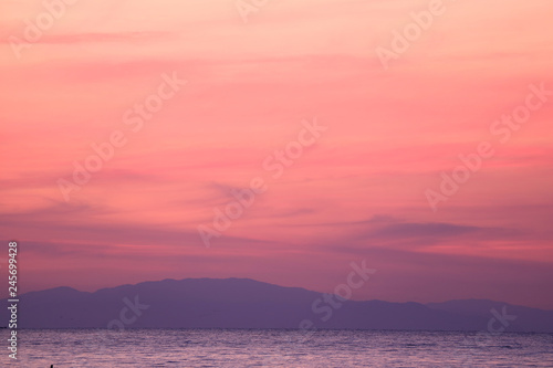 Stunning Pastel Pink and Purple Sunrise Sky over the Gulf of Thailand with the Mountain Range in the Backdrop 
