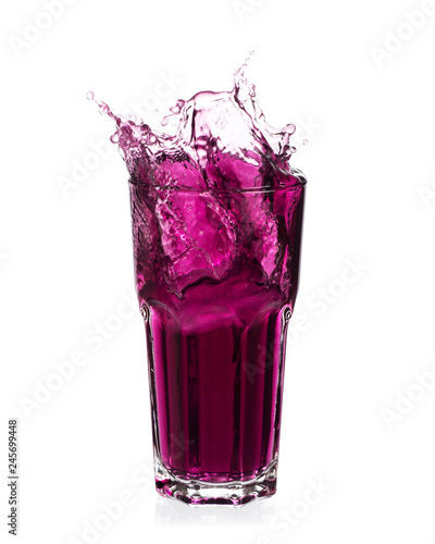 Fotografía Grape juice splash out of glass isolated on white background.