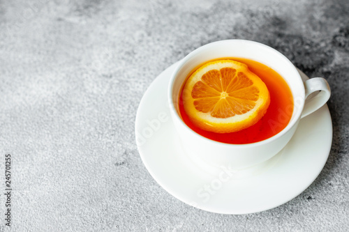 Tea, lemon, hot, drink. Tasty fragrant hot tea with a lemon on a concrete background