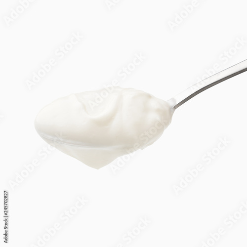 Yogurt in spoon isolated