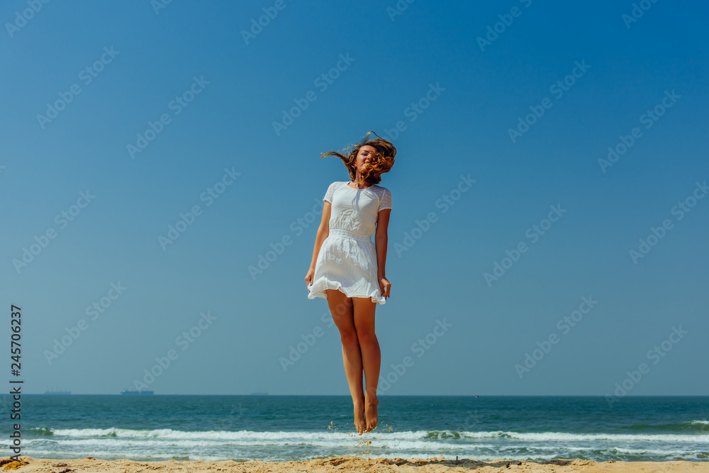 Beautiful Joyfull Girl Jumping on The Beach. Vacation and Relaxing Beautiful Joyfull Girl Jumping on The Beach. Vacation and Relaxing